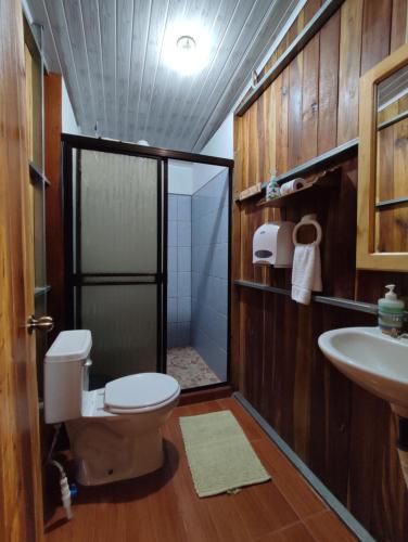 a bathroom with a toilet and a sink at Casitas de Montaña Cabuya in Monteverde Costa Rica