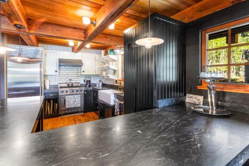 a kitchen with a large black counter top at Serene Lakes Splendor in Soda Springs