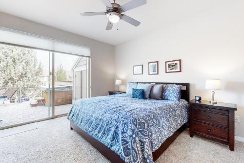 a bedroom with a bed and a ceiling fan at Pines and Blue Skies in Redmond