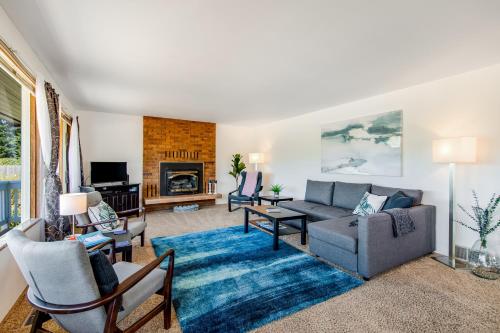 a living room with a couch and a table at Home on Holmes in Freeland