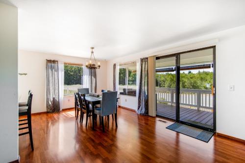 a dining room and living room with a table and chairs at Home on Holmes in Freeland