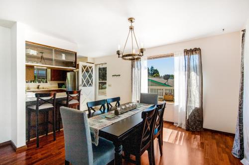 a dining room and kitchen with a table and chairs at Home on Holmes in Freeland