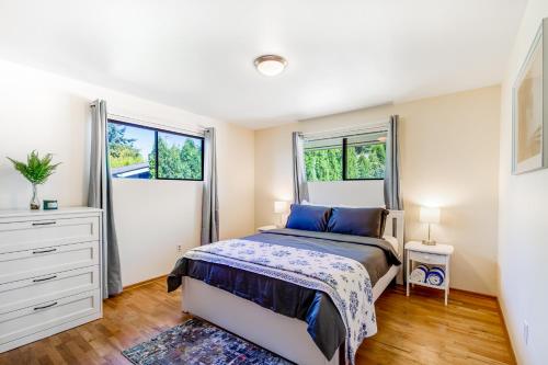 a bedroom with a bed and two windows at Home on Holmes in Freeland