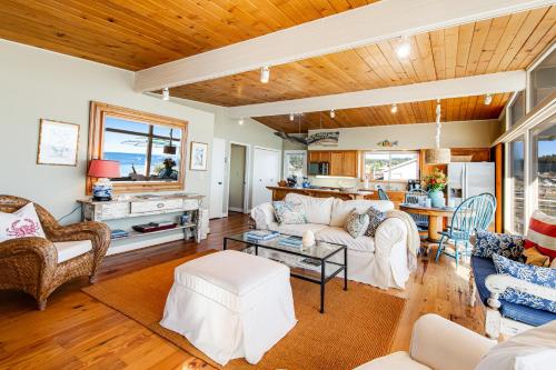a living room with a couch and a table at Sunlight Beach Shoreline in Clinton