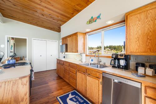 a kitchen with wooden cabinets and a large window at Sunlight Beach Shoreline in Clinton