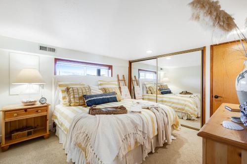 a bedroom with two beds and a mirror at Sunlight Beach Shoreline in Clinton
