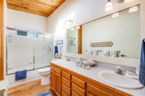 a bathroom with a sink and a toilet and a mirror at Sunlight Beach Shoreline in Clinton