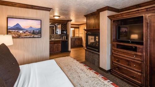 a bedroom with a bed and a tv in a room at Best Western Plus Flathead Lake Inn and Suites in Kalispell