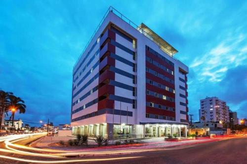 a tall building on the side of a street at Hotel Caiçara João Pessoa in João Pessoa