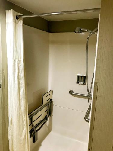 a bathroom with a shower with a shower curtain at NavajoLand Hotel in Tuba City