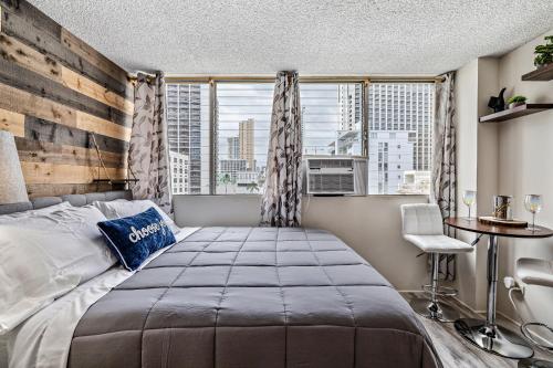 a bedroom with a large bed and a window at Modern WAIKIKI CONDO perfect for beach getaway! in Honolulu