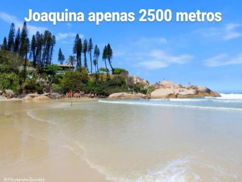 a view of a beach with trees and water at Pousada Quintal Verde Floripa in Florianópolis
