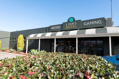 a building with a lot of plants in front of it at Links Hotel in Adelaide