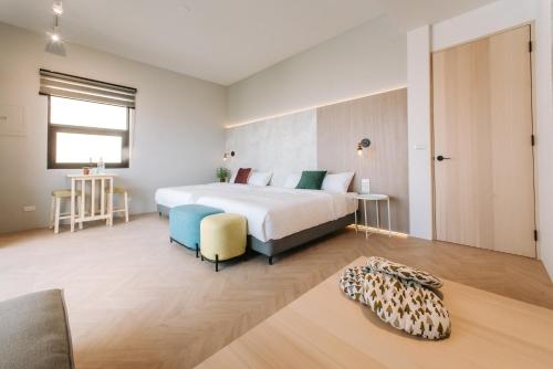 a bedroom with a large white bed and a couch at AiMen Homestay in Huxi