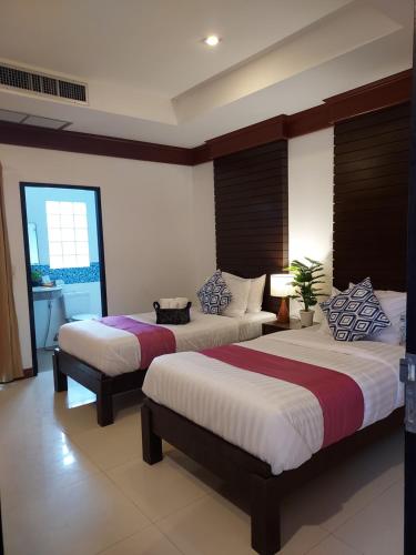a bedroom with two beds and a window at Aromdee at Naithon Beach in Nai Thon Beach