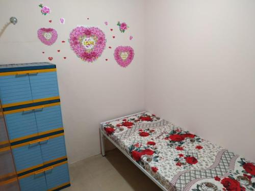a bedroom with a bed with flowers on the wall at Eiffel Residence Petojo - Female Only in Jakarta