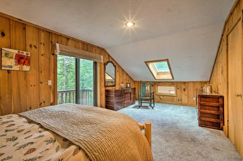 ein Schlafzimmer mit einem Bett in einem Zimmer mit Holzwänden in der Unterkunft Spacious Dover Home with Sauna Less Than 5 Miles to Ski! in Dover