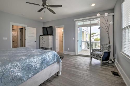 Un dormitorio con una cama y un televisor y una ventana. en Luxury Townhouse with Ocean Views - Walk to Ocean!, en Kure Beach