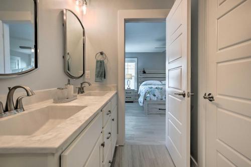 Un baño blanco con lavabo y espejo. en Luxury Townhouse with Ocean Views - Walk to Ocean!, en Kure Beach