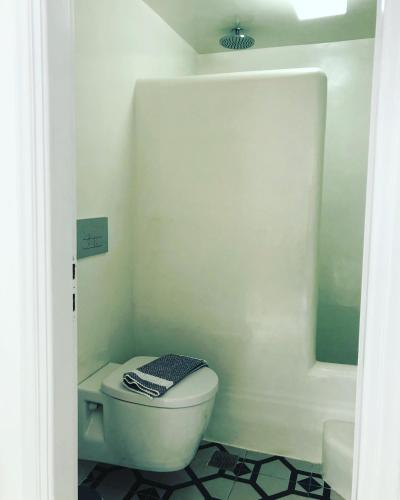 a bathroom with a white toilet and a mirror at Taki's Guests in Naxos Chora