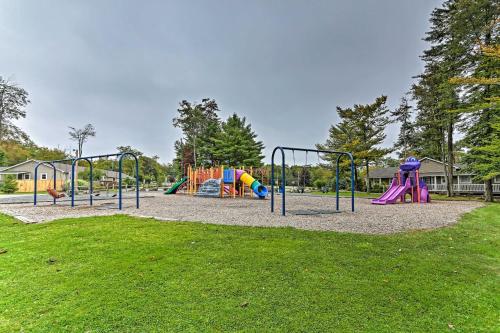 a park with a playground with slides at Walk to Lake Tobyhanna Home with Hot Tub and Fire Pit in Tobyhanna