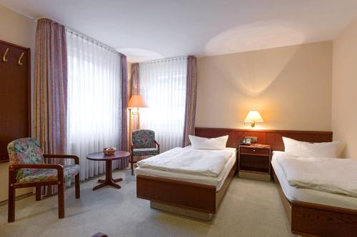 Un ou plusieurs lits dans un hébergement de l'établissement Hotel Altdeutsche Weinstuben