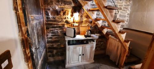 a small kitchen with a counter in a room with stairs at b&b La Corte dei Cerri- Il Piccolo Chalet in Frassinoro