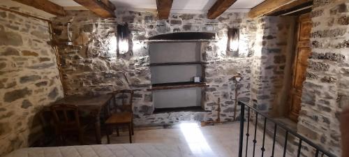 a room with a stone wall with a window at b&b La Corte dei Cerri- Il Piccolo Chalet in Frassinoro