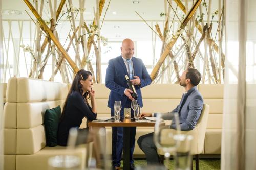 a group of people sitting around a table talking at Spa Resort Styria- ADULTS ONLY in Bad Waltersdorf