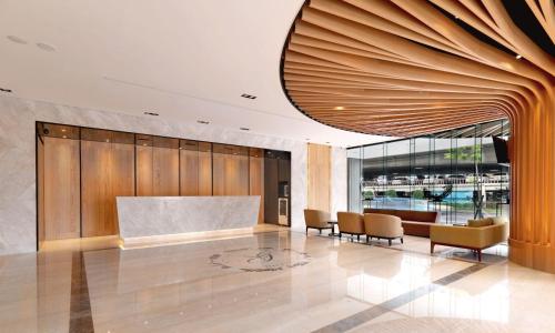 a lobby with a table and chairs in a building at Green World Grand NanJing in Taipei