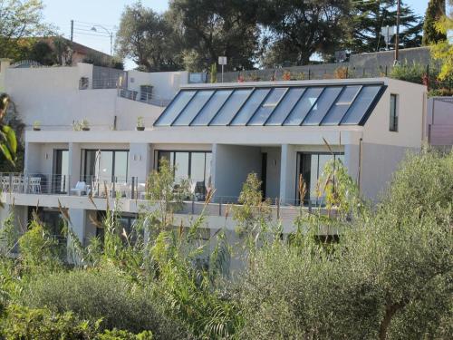 a house with solar panels on the side of it at Villa 5* Nice St Pancrace in Nice