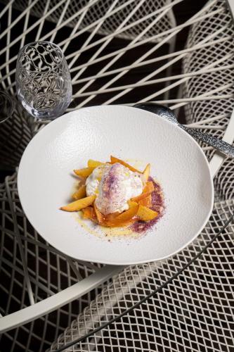a white plate of food on a table at En Marge in Aureville