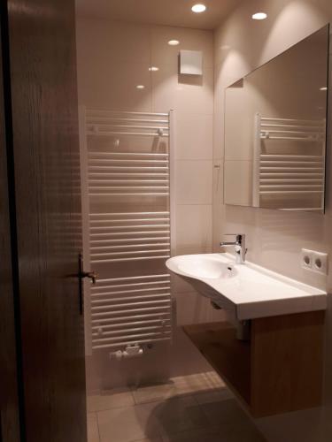 La salle de bains est pourvue d'un lavabo et d'un miroir. dans l'établissement Haus Güatli, à Gaschurn