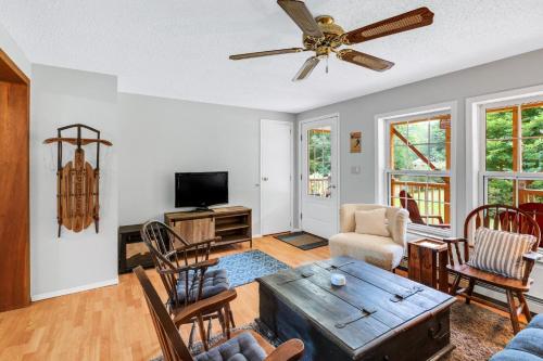 a living room filled with furniture and a ceiling fan at Chandler Hill Base Camp - Enjoy A Nature Getaway in this Rustic Home in the Mountains, 10 minutes from Sunday River Ski Mountain! home in Bethel