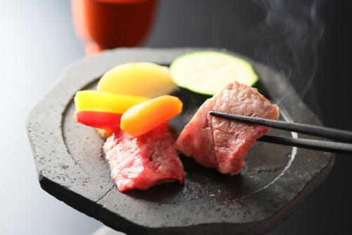 a plate of food with meat and vegetables on it at Awanoyu in Matsumoto