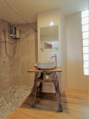 a bathroom with a sink and a mirror at Saffron On The Sea Resort in Ko Chang