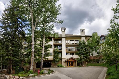 a large building with trees in front of it at Townsend Place B-106 condo in Beaver Creek
