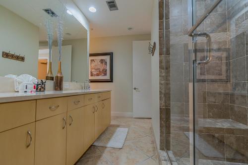 a bathroom with a shower stall and a sink at Seas the Day in this Luxury Condo at Diamond Beach Ocean Views Incredible Pools Amenities in Galveston