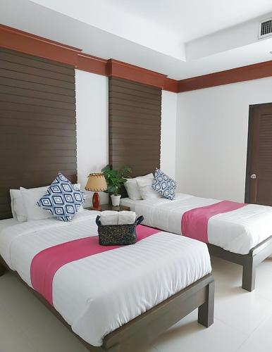 two beds sitting in a room with at Aromdee at Naithon Beach in Nai Thon Beach