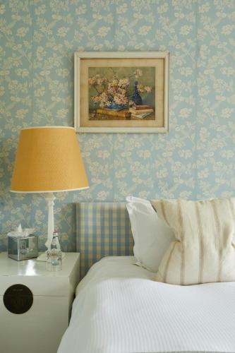 a bedroom with a bed and a picture on the wall at The Kingham Plough in Kingham