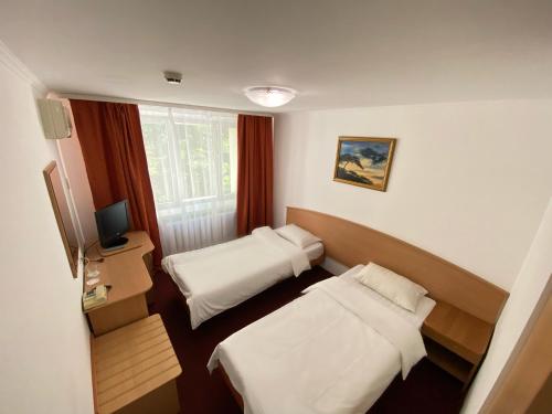 Кровать или кровати в номере Парк Отель Фили 