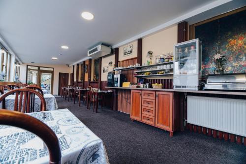 a restaurant with a bar with chairs and a table at Point Pension in Brno