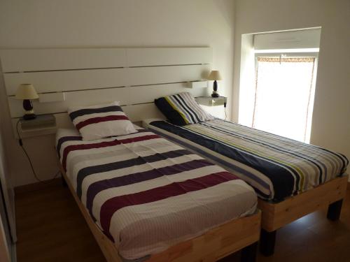 two beds sitting next to each other in a bedroom at Aux Pierres de Nozières in Gramat