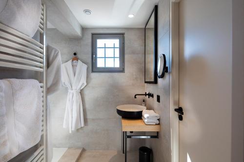 a bathroom with a white robe hanging on a wall at Atmospheres in Le Bourget-du-Lac