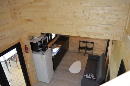 an overhead view of the kitchen and living room of a tiny house at Le Village des Monédières in Chamberet
