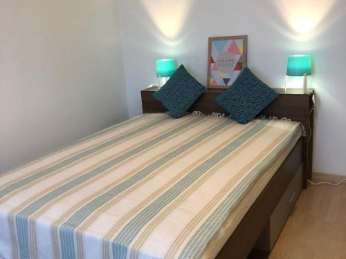 a bedroom with a bed with a striped mattress at Casella - Appartement centre ville tout équipé in Bastia