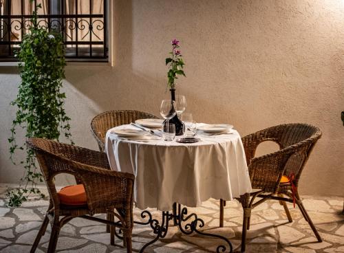 a table with wine glasses and a vase on it at Antica Casina B&B di Charme in Pulsano