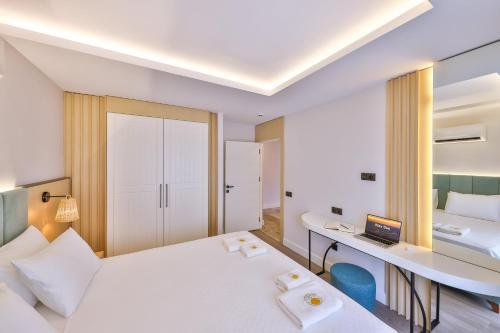 a hotel room with two beds and a desk at Sole Vista Homes in Kas