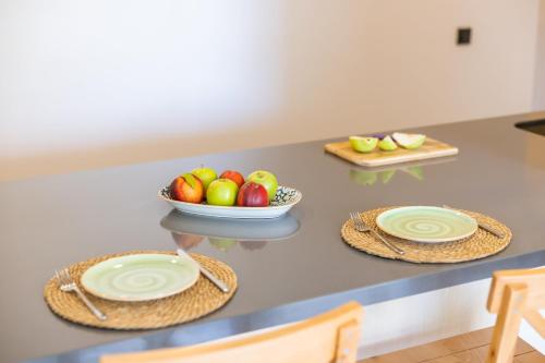 a table with plates and a bowl of fruit on it at Sole Vista Homes in Kas