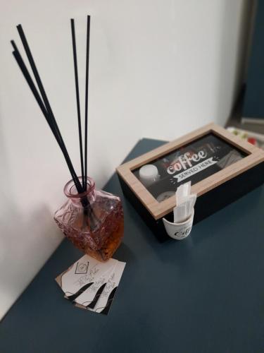 a table with a vase and a box of chopsticks at WiSaRelax in Brusciano